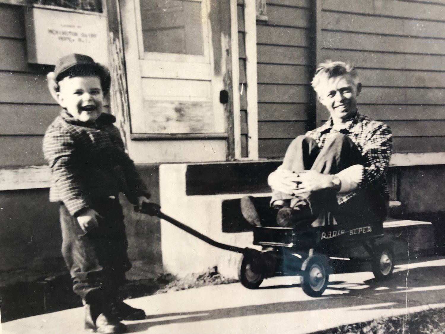 Wheels of all kinds figured prominently in the Rounds family. A young Billy Rounds tows his father Harold around in his own set of wheels in 1954.